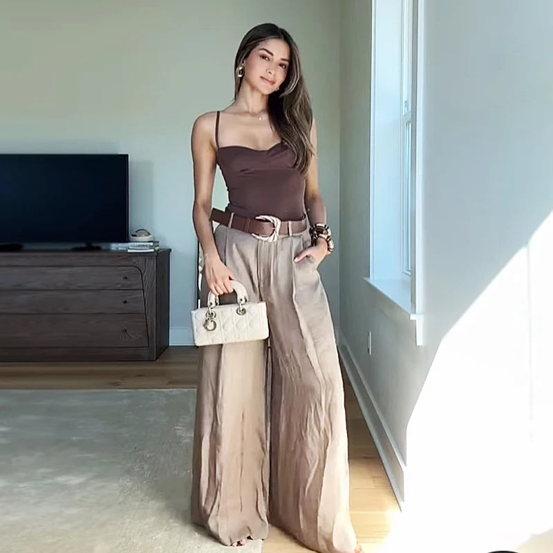 Made from lightweight, breathable fabric, it features a palazzo-style silhouette that elongates the silhouette, a high waistband that accentuates the waist, and an impeccable fit that guarantees sophistication for any occasion.