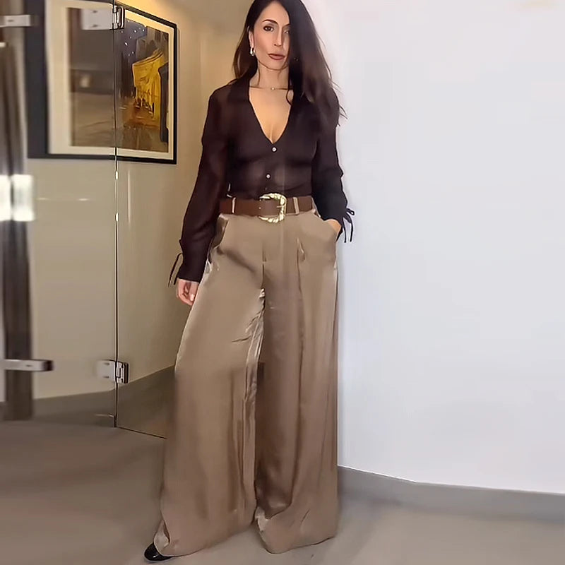 Made from lightweight, breathable fabric, it features a palazzo-style silhouette that elongates the silhouette, a high waistband that accentuates the waist, and an impeccable fit that guarantees sophistication for any occasion.