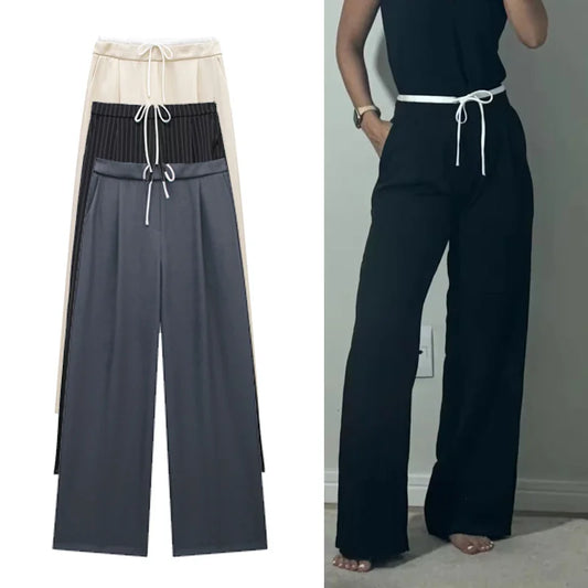 Made from soft, breathable fabric, it features a loose fit that elongates the silhouette, a high waist with drawstring adjustment, and a loose fit for maximum comfort. Ideal for casual looks, work, or leisure.
