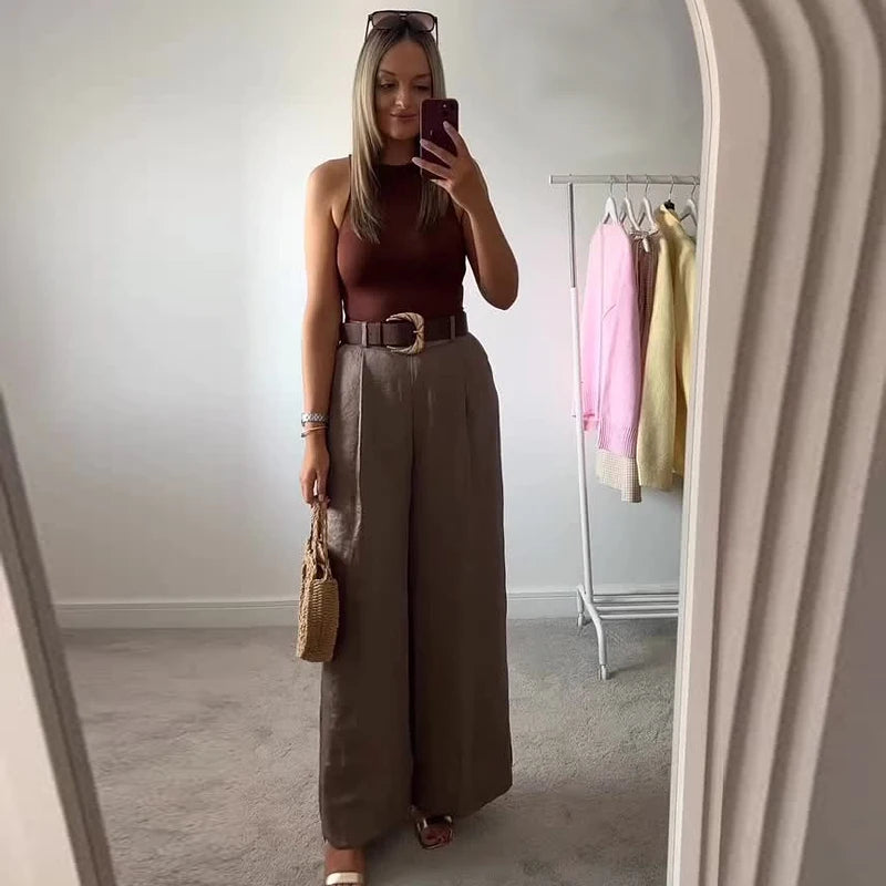 Made from lightweight, breathable fabric, it features a palazzo-style silhouette that elongates the silhouette, a high waistband that accentuates the waist, and an impeccable fit that guarantees sophistication for any occasion.
